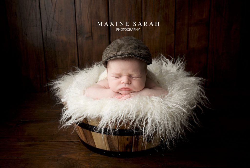 newborn baby portrait photograph photography cute baby grandad cap wooden bowl creamy skin fluff