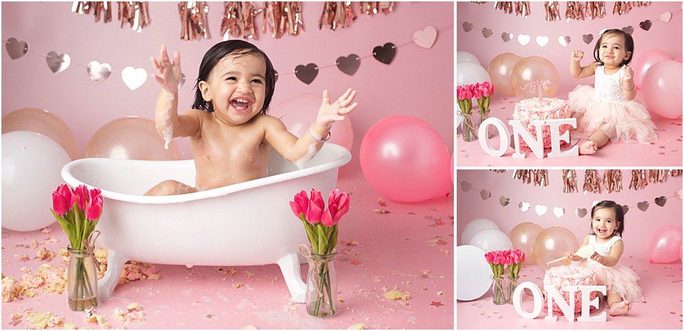 baby girl aged one in bath and eating cake for first birthday cake smash